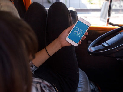 iPhone Mockup Featuring a Woman Chilling in the Front Seat of a Car 