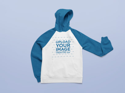 Mockup of a Raglan Hoodie Placed on a Plain Surface 25309