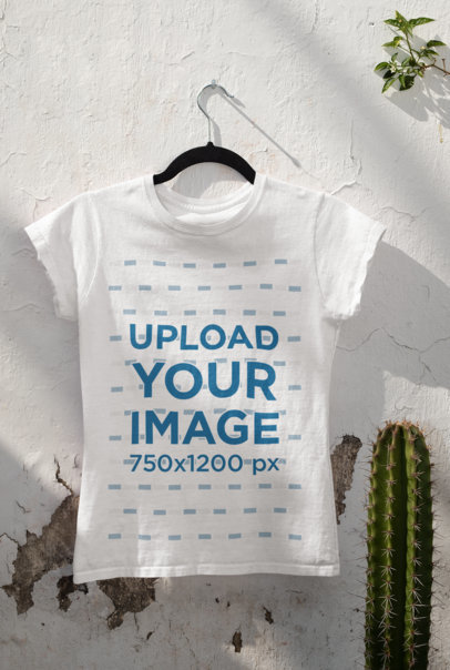 Mockup of a T-Shirt Hanging By a Cactus 