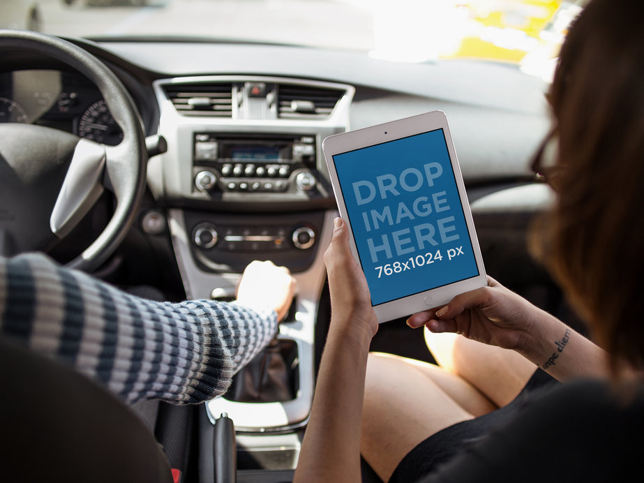Mockup of an iPad in Portrait Position Featuring Two Women During a Car Ride