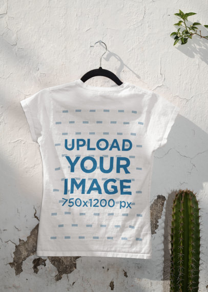 Mockup of the Back of a T-Shirt Hanging Next to a Cactus