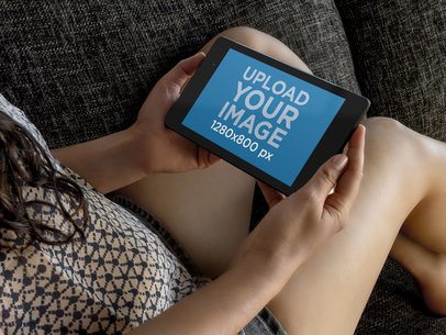 Nexus 7 Mockup Featuring a Woman Relaxing on a Couch 