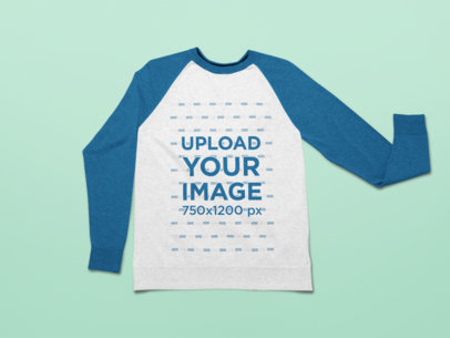 Mockup of a Raglan Sweatshirt Laid on a Customizable Surface 25500