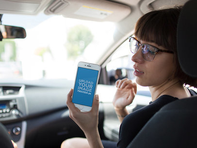 Mockup of a Woman Showing an iPhone 6 in Portrait Position in the Passenger's Seat