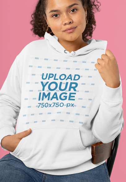 Hoodie Mockup of a Curly-Haired Woman Posing on a Chair