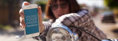 iPhone 7 Mockup Held in Portrait Position by a Girl with a Plaid Shirt and Short Hair on a Motorcycle a12955wide