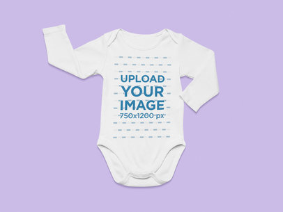 Flat Lay Mockup of a Long-Sleeve Onesie on a Flat Surface