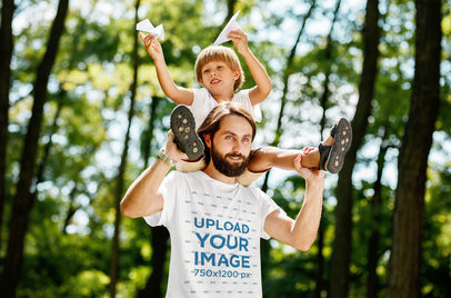 T-Shirt Mockup of a Man Playing with His Son on the Woods