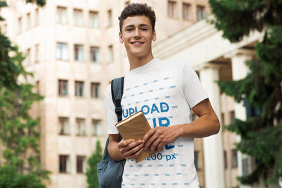 T-Shirt Mockup of a Young Man Holding a Book