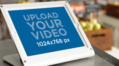 Video of a Woman Using an iPad on a Store Counter