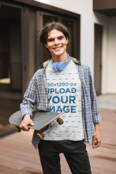 T-Shirt Mockup of a Smiling Man Holding a Skateboard