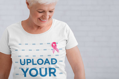 Mockup of a Senior Woman Wearing a T-Shirt with a Pink Ribbon 34103-r-el2