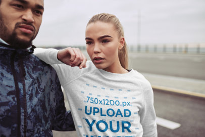 Mockup of a Woman Wearing a Sweatshirt on a Rainy Day 