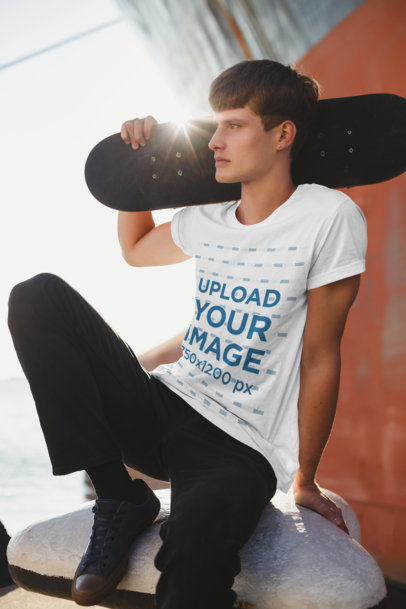 T-Shirt Mockup of a Cool Man Posing with a Skateboard