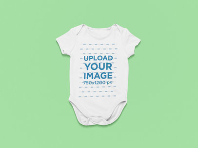 Mockup of a Short-Sleeve Onesie on a Customizable Surface