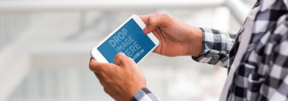 iPhone 7 Plus Mockup of a Young Man Playing in Landscape View at his Apartment