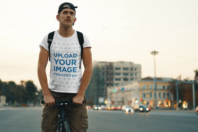 T-Shirt Mockup of a Man Riding a Bicycle on the Street 