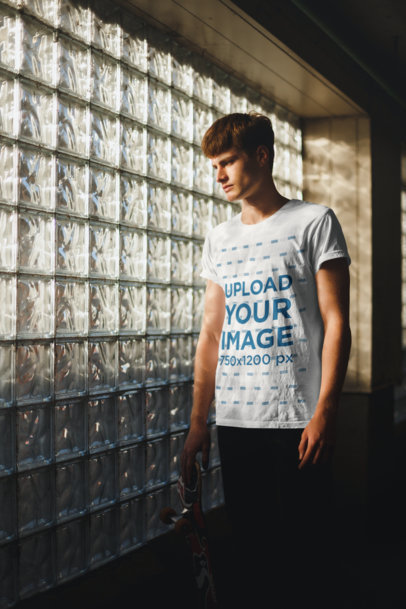 T-Shirt Mockup of a Man Staring Through a Window Wall