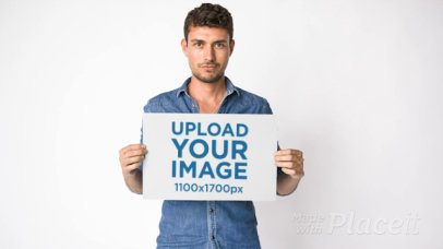 Video of a Curly-Haired Man Holding a Poster in Front of Him