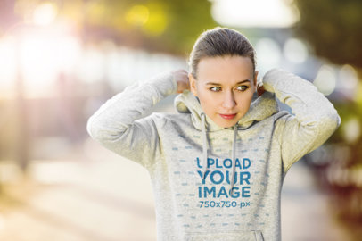 Mockup of a Female Jogger Wearing a Heathered Pullover Hoodie