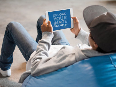 iPad Mini Mockup of a Gamer Guy Sitting on a Bean Bag Chair Playing 13043