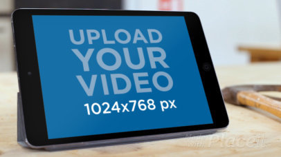 Mockup of a Man Using an iPad in a Workshop 9022