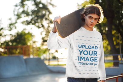 Sweatshirt Mockup of a Young Man Posing with His Skateboard