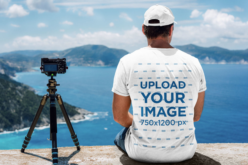 Back View T-Shirt Mockup of a Man with a Camera Contemplating the Ocean 
