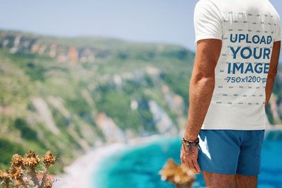 T-Shirt Mockup of a Man at the Top of a Mountain