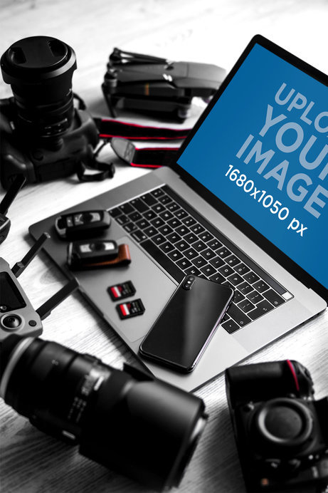 Mockup Featuring a MacBook Pro Surrounded by Photography Equipment