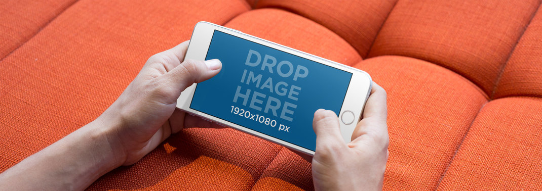 Young Woman Holding a White iPhone 7 Plus in Landscape View Mockup While Playing on the Sofa