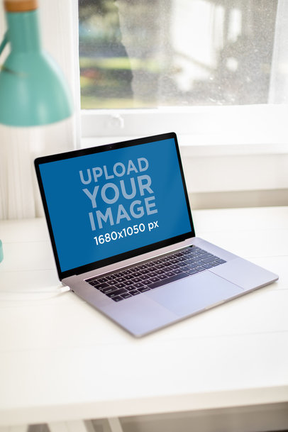 Mockup Featuring a Macbook Pro Placed on a Minimal Desk 