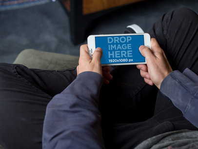 Mockup Featuring a Teenager Playing on His iPhone