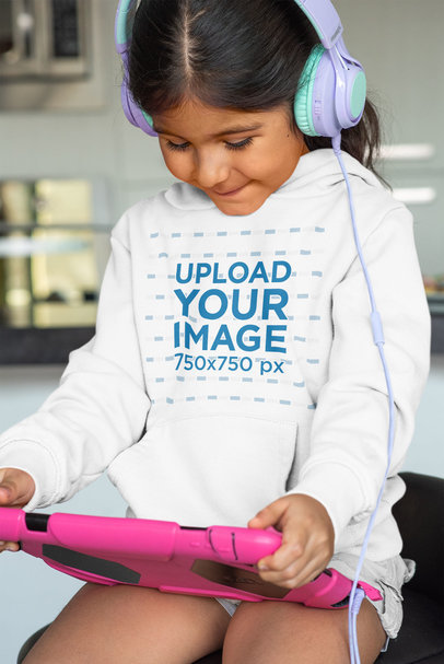 Mockup of a Little Girl with Headphones Wearing a Pullover Hoodie