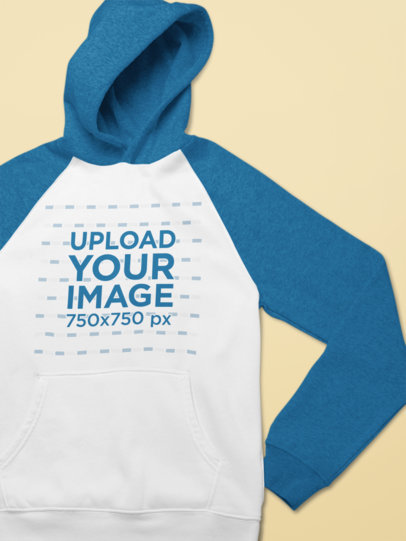 Closeup View Mockup of a Raglan Hoodie on a Flat Surface 25558