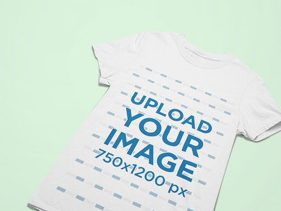 Flat Laid Mockup of a T-Shirt Lying on a Plain Surface 