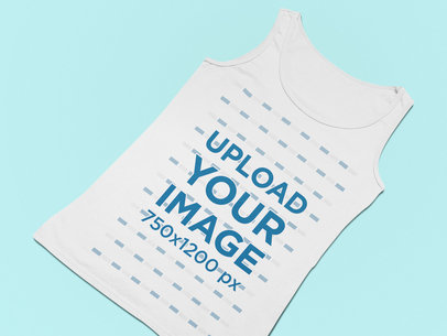 Mockup of a Flat Laid Tank Top Against a Solid Surface