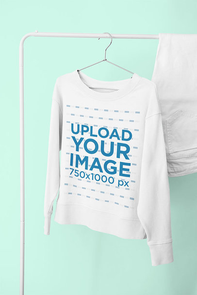 Mockup of a Round Neck Sweatshirt Hanging on a Rack 33977