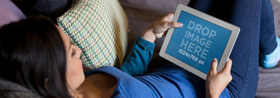 iPad Mockup in Landscape View Featuring a Woman in her Living Room Playing