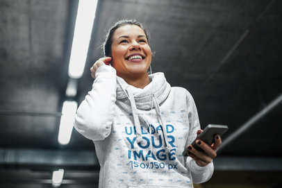 Mockup of a Jogging Woman Putting on Her Headphones