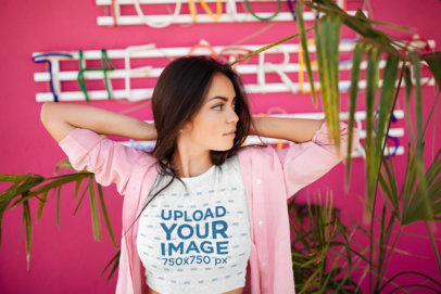 Crop Top Tee Mockup of a Woman Posing by a Pink Wall 