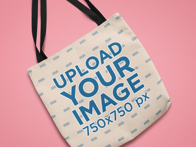 Mockup of a Sublimated Tote Bag Against a Customizable Surface