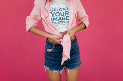 Cropped Face Mockup of a Woman with a Heather Crop Top Standing by a Pink Wall