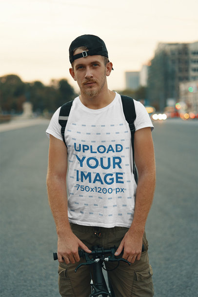 T-Shirt Mockup Featuring a Man with a Bicycle on the Street