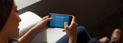 Woman at Home Playing with her iPhone 7 Plus in Landscape Position Mockup