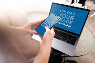 MacBook Mockup Featuring a Woman Using Her iPhone 11 Pro