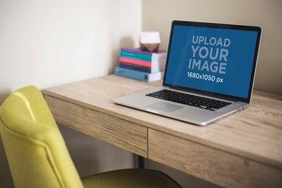 Mockup of a MacBook Pro Placed on a Wooden Desk