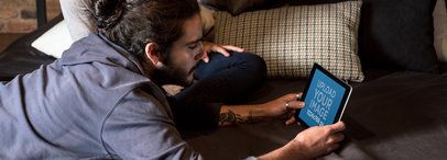 Ipad Mockup in Landscape Position Featuring a Man Lying on a Couch