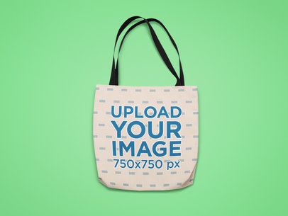 Mockup of a Sublimated Tote Bag Against a Customizable Surface
