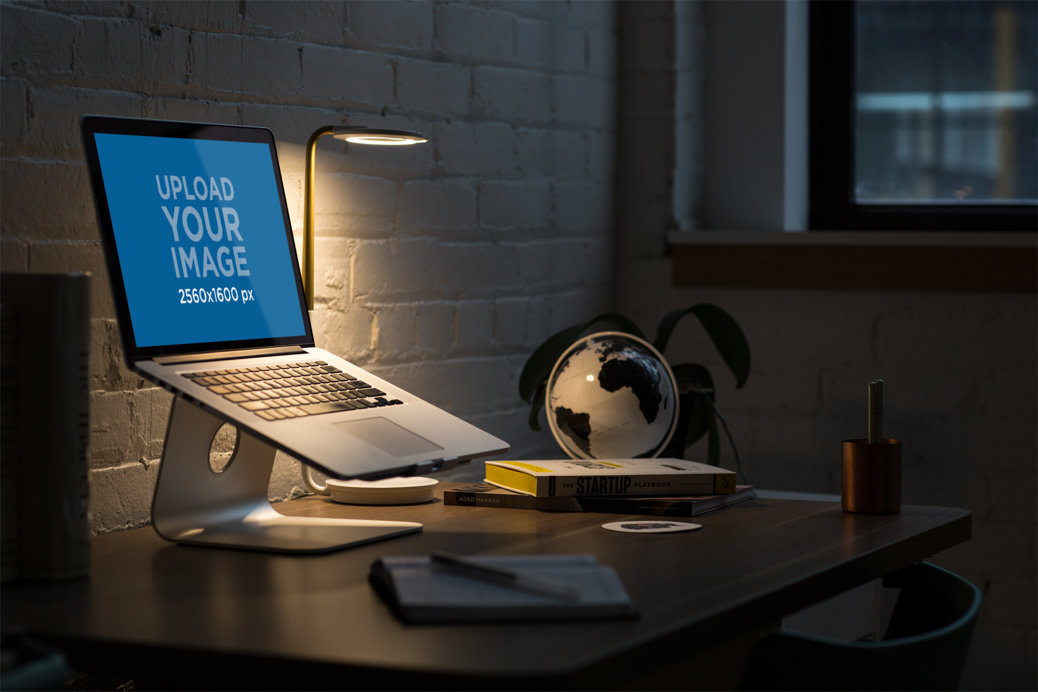 MacBook Mockup Featuring a Desk with Dim Light